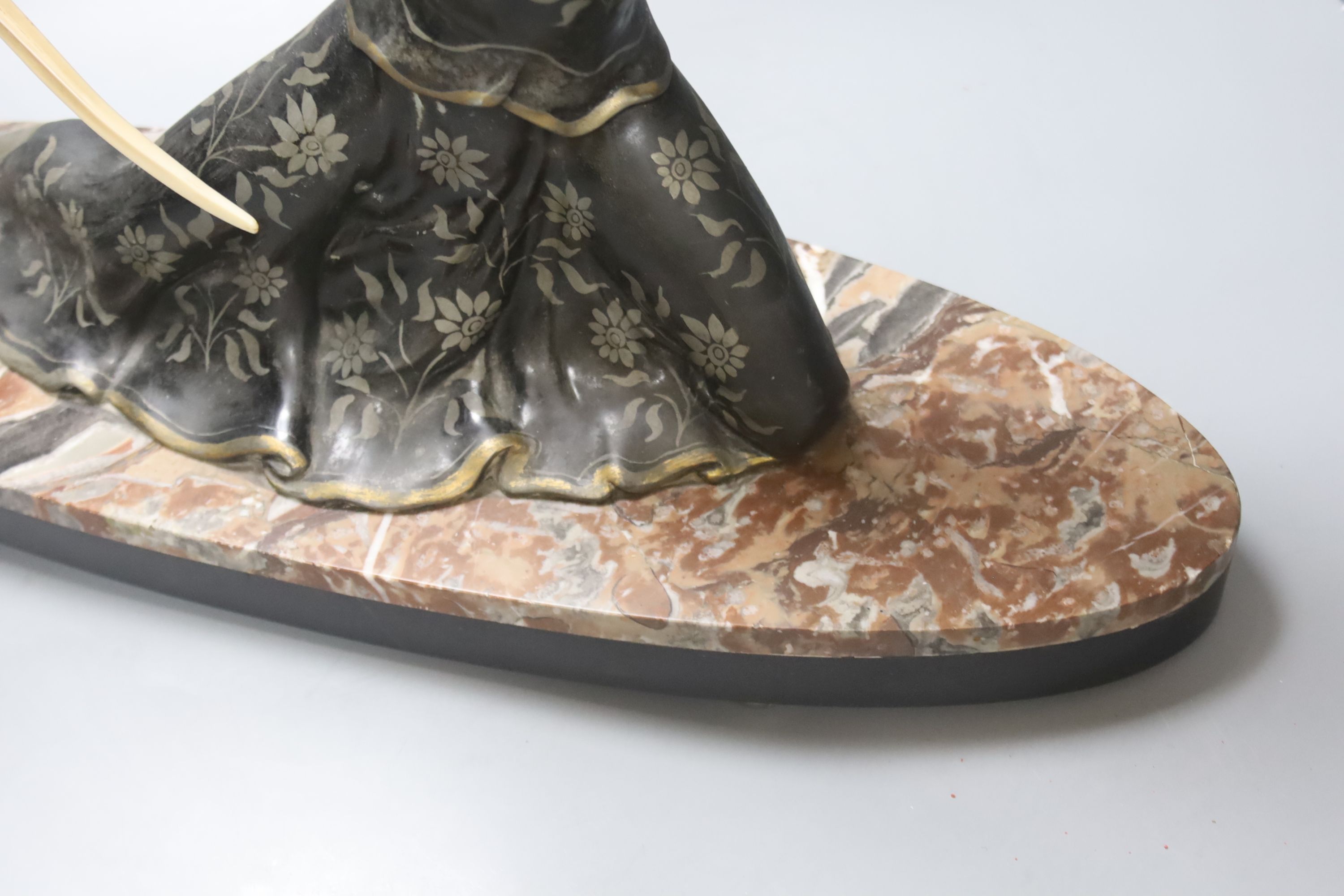 An Art Deco style spelter and marble figure of a female archer, base length 55cm